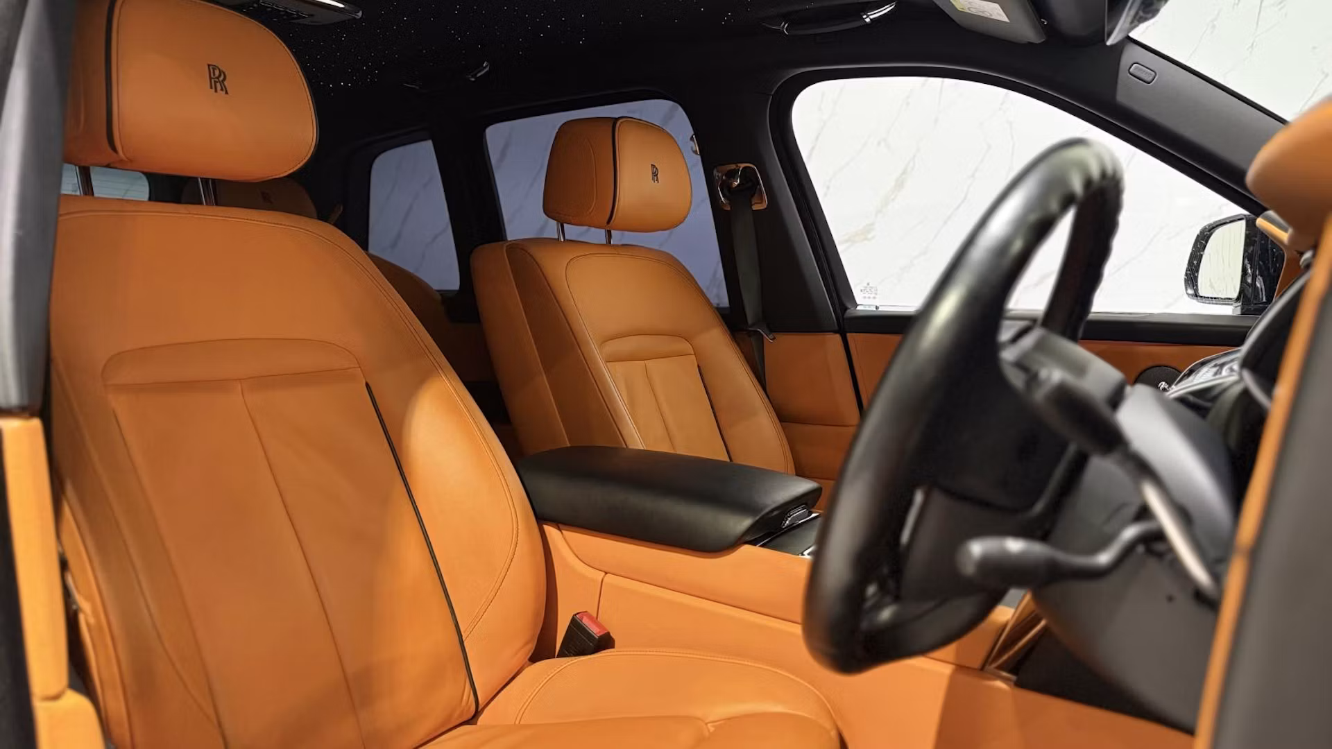 Luxury car interior with steering wheel detail